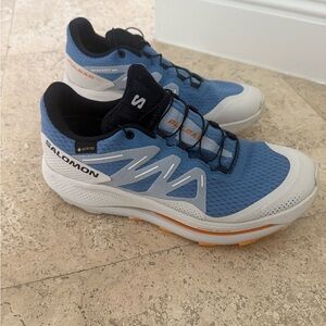 Salomon women’s Blue and White Pulsar Trail Sneakers with Orange Accents